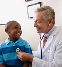 Doctor listening to child's heartbeat with stethoscope